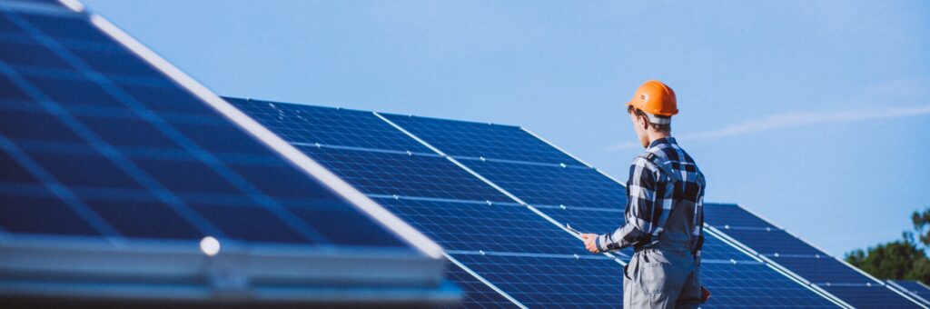 Picture of man standing in front of solar panels